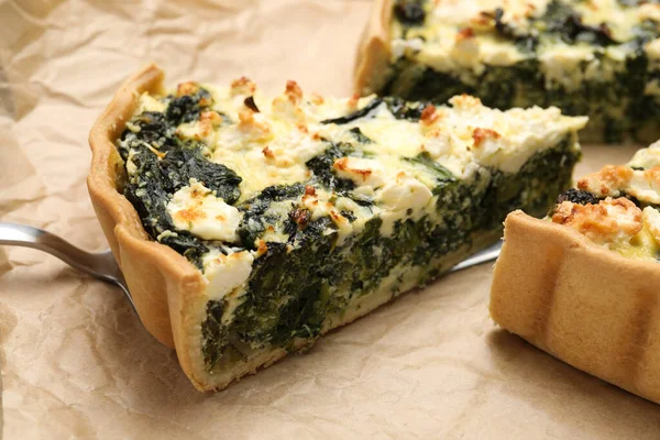 Stock image Delicious homemade spinach quiche on parchment paper, closeup