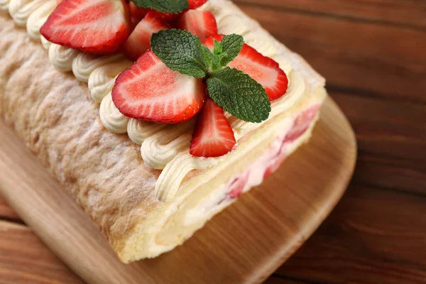 stock image Delicious cake roll with strawberries and cream on table closeup