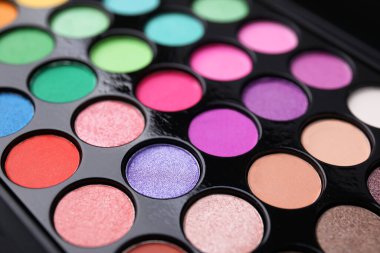 Beautiful eyeshadow palette as background, closeup. Professional cosmetic product