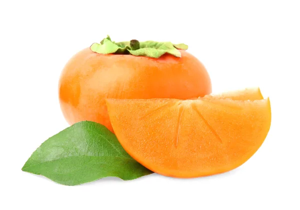 stock image Whole and cut delicious ripe juicy persimmons with green leaf on white background