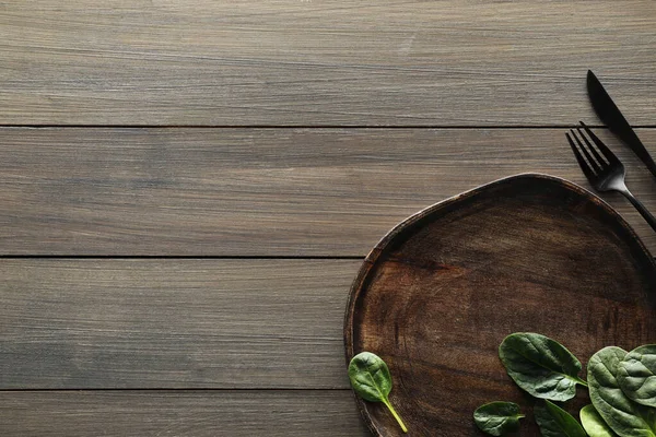 stock image Food photography. Fresh basil, board and cutlery on wooden table, flat lay with space for text