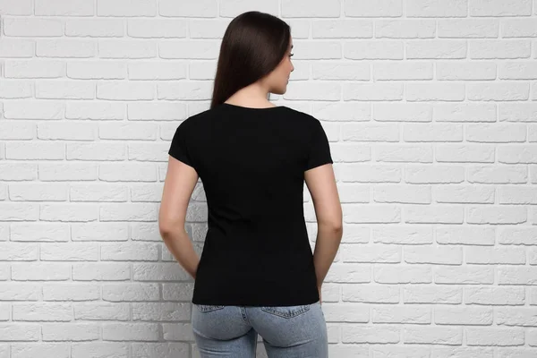 Kvinna Bär Snygg Svart Shirt Nära Vit Tegelvägg Baksida — Stockfoto