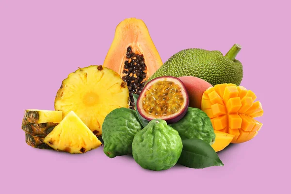 Many different fresh fruits on violet background