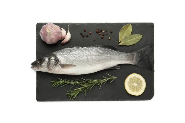 stock image Tasty sea bass fish and ingredients isolated on white, top view