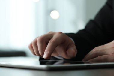 Kapalı alanda yeni tablet kullanan bir adamın yakın görüntüsü