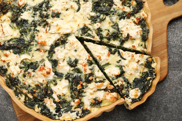 stock image Delicious homemade spinach quiche on gray table, top view