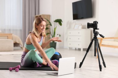 Fitness trainer recording online classes at home