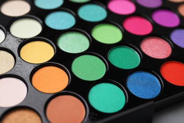 Beautiful eyeshadow palette as background, closeup. Professional cosmetic product