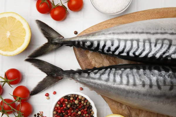 stock image Raw mackerel, tomatoes and lemon on white table, flat lay