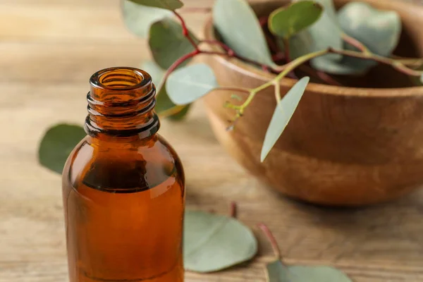 Bottle Eucalyptus Essential Oil Leaves Wooden Table Closeup Space Text — Stock Photo, Image