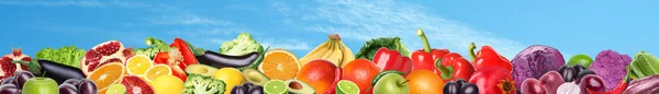 stock image Many different fresh fruits and vegetables against blue sky with clouds. Banner design