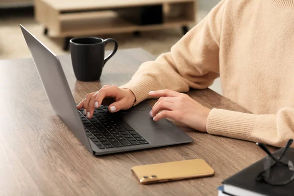 stock image Woman working with laptop at wooden desk indoors, closeup
