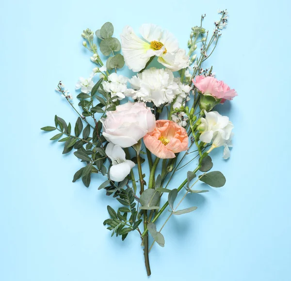 Different beautiful flowers on light blue background, flat lay