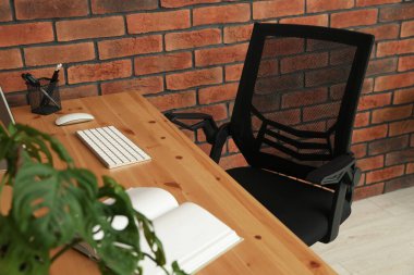 Comfortable office chair near desk at workplace