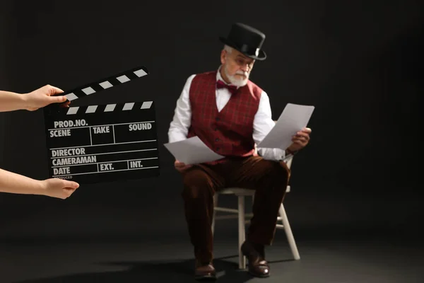 Senior Actor Performing Role While Second Assistant Camera Holding Clapperboard — Stock fotografie