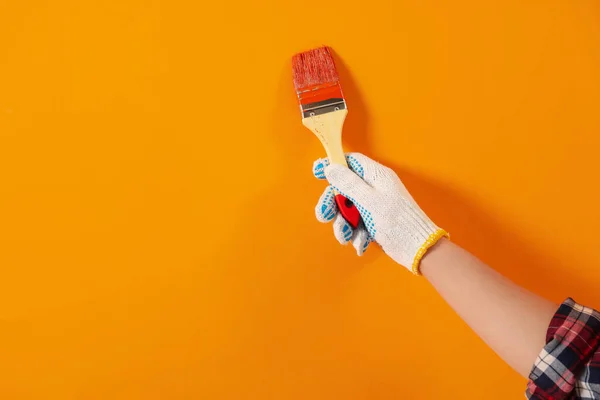 Diseñador Pintando Pared Naranja Con Pincel Primer Plano Espacio Para — Foto de Stock