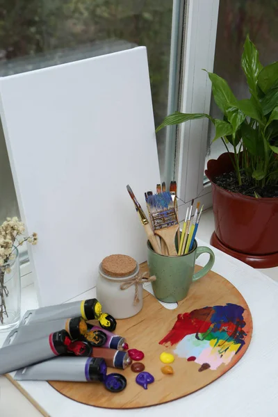 Wooden Artist Palette Colorful Paints Brushes Canvas White Windowsill — Fotografia de Stock
