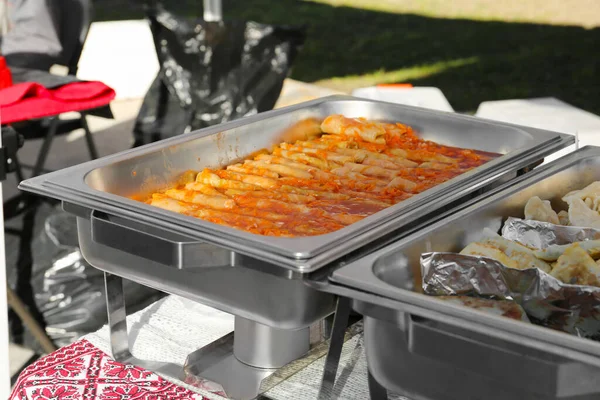 屋外のテーブルの上に暖かいでおいしい詰めキャベツ 餃子とパテ ボランティア食品流通 — ストック写真