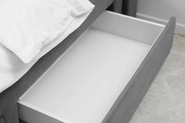 stock image Storage drawer for bedding under modern bed in room