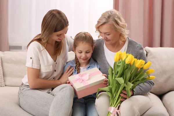 Little Girl Congratulating Her Mom Granny Flowers Gift Home Happy — Stock Photo, Image