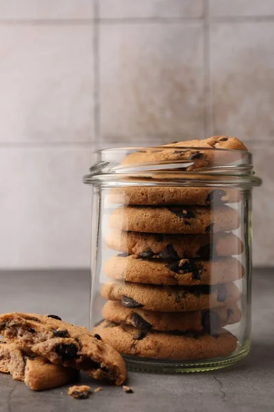 Glass Jar Delicious Chocolate Chip Cookies Grey Table — Stock Photo, Image