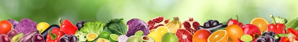 stock image Many different fresh fruits and vegetables against blurred green background. Banner design