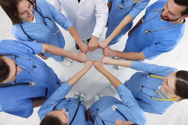 Doctor Interns Holding Fists Together Indoors Top View — Stock Photo, Image