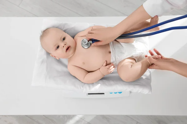 儿科医生在临床 特写镜头下 用听诊器对可爱的小宝宝进行称重和检查 — 图库照片