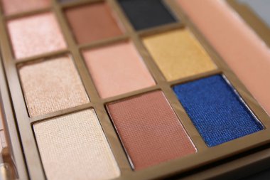 Beautiful eyeshadow palette as background, closeup. Professional cosmetic product