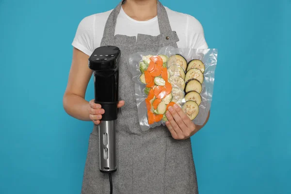 Γυναίκα Κρατώντας Sous Vide Κουζίνα Και Λαχανικά Συσκευασίες Κενού Γαλάζιο — Φωτογραφία Αρχείου