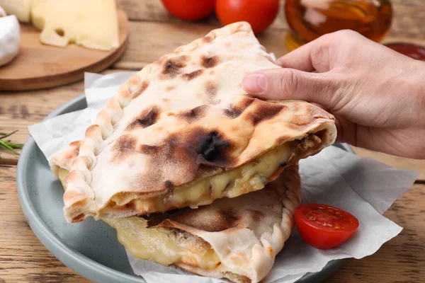 Woman Holding Tasty Pizza Calzone Cheese Wooden Table Closeup — Stock Photo, Image