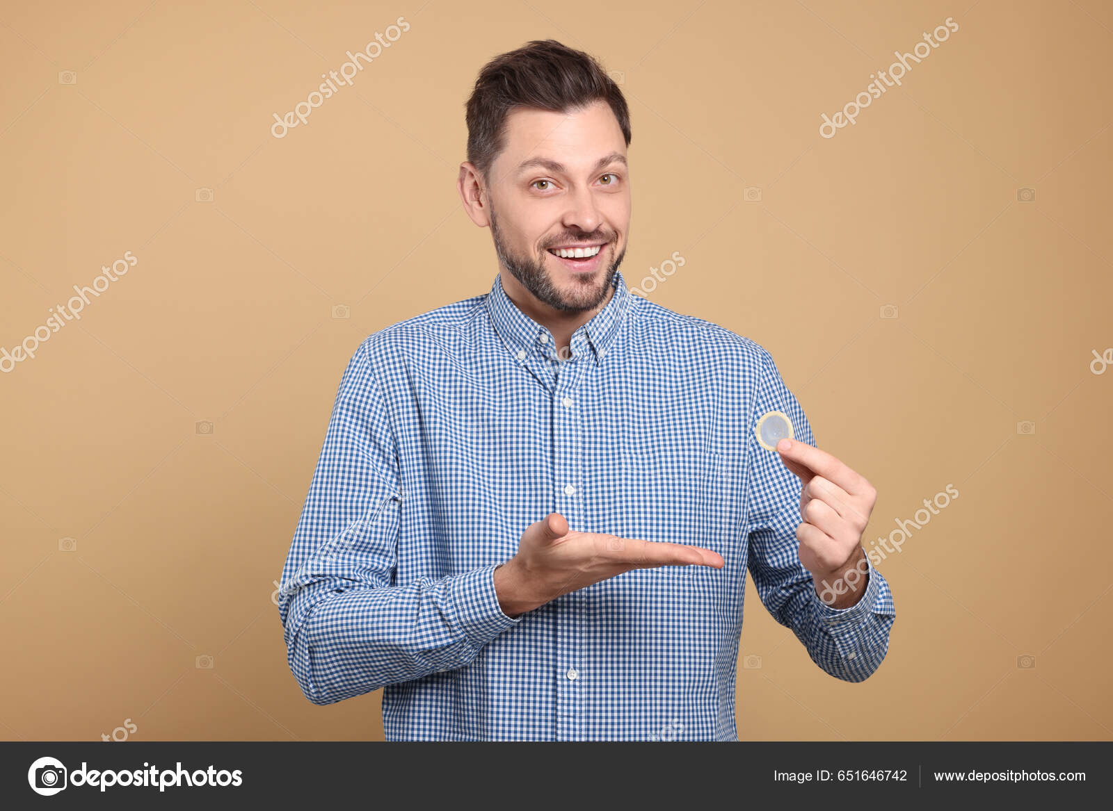 Happy Man Holding Condom Beige Background Closeup Stock Photo By.