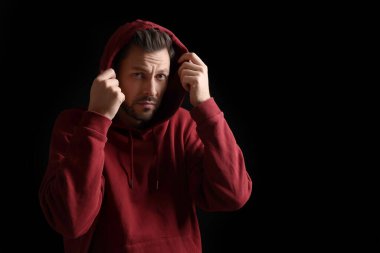 Portrait of sad man on black background. Space for text