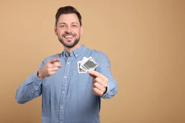 Happy Man Holding Condoms Beige Background Space Text — Stock Photo, Image