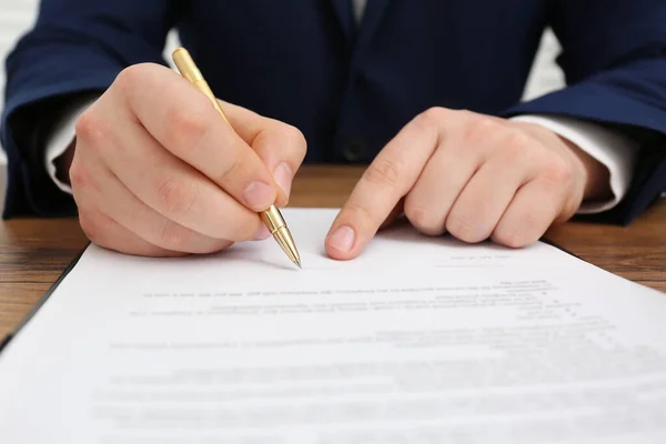 Man Signing Document Wooden Table Closeup Stock Picture