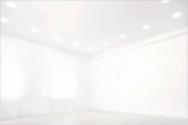 Empty room with windows and white wall, blurred view