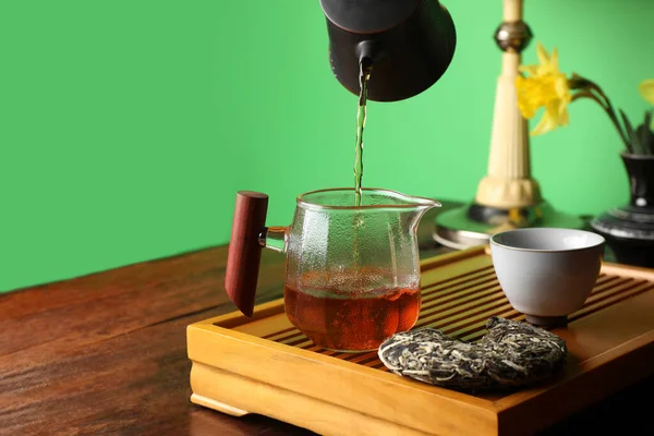 在传统的木桌仪式上 在水壶里倒入新鲜的泡芙茶 案文的篇幅 — 图库照片