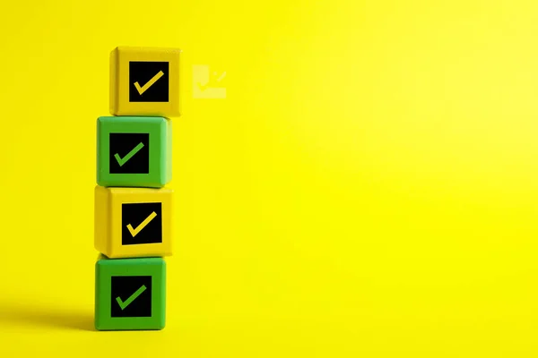 stock image Stacked cubes with check marks on yellow background. Space for text