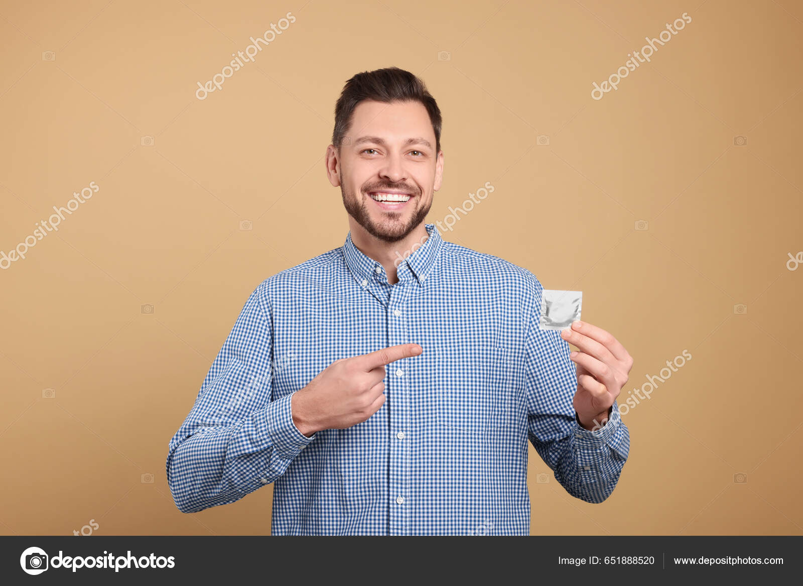 Happy Man Holding Condom Beige Background Closeup Stock Photo By.