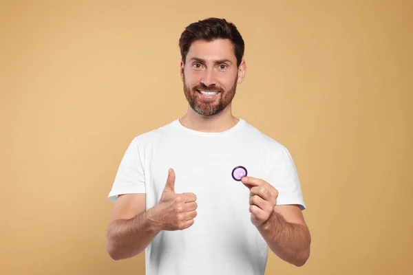 Happy Man Condom Showing Thumb Beige Background Safe Sex — Stock Photo, Image