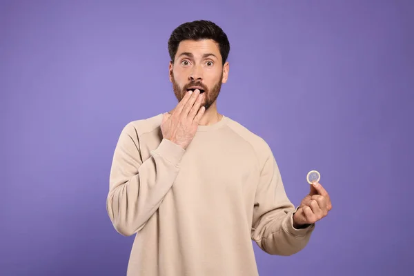 Muž Držící Kondom Fialovém Pozadí Bezpečný Sex — Stock fotografie