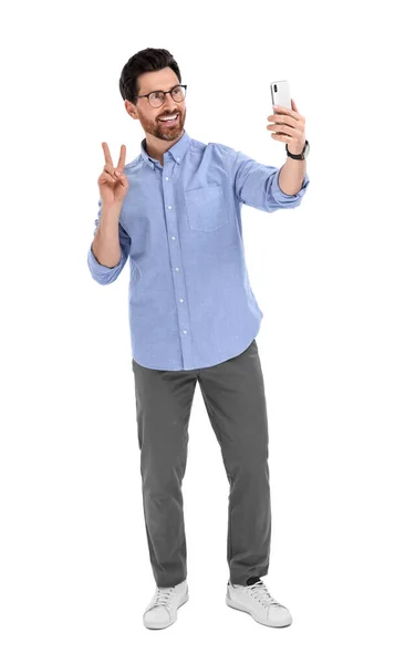 Smiling Man Taking Selfie Smartphone Showing Peace Sign White Background — Stock Photo, Image