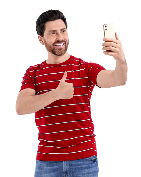 笑顔男取る自画自賛とスマートフォンと親指を上に白い背景 — ストック写真