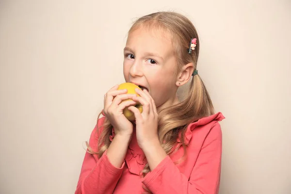 Cute Little Girl Eating Apple Light Background — Stock Photo, Image