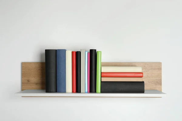 Different Books Wooden Shelf White Wall — Stock Photo, Image