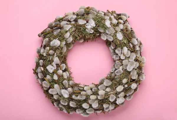 stock image Wreath made of beautiful willow flowers on pink background, top view