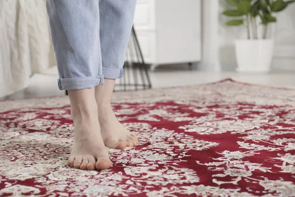 stock image Woman standing on carpet with pattern at home, closeup. Space for text