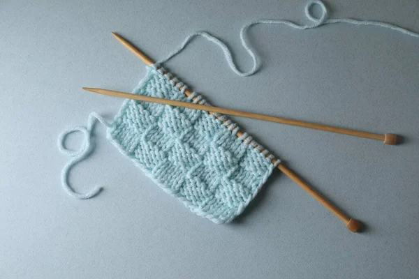 Soft Turquoise Knitting Needles Light Blue Background Top View — Stock Photo, Image