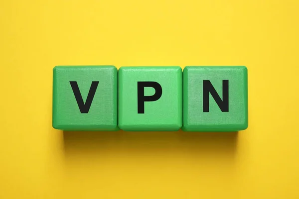 stock image Green cubes with acronym VPN on yellow background, top view