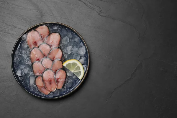 stock image Raw mackerel slices, ice cubes and lemon on grey table, top view with space for text. Fish delicacy